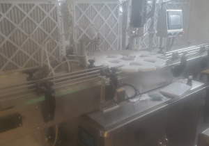 Used Automatic pneumatic liquid bottle filling and capping machine with rotary top and conveyors
