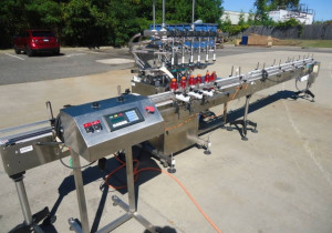 Used Inline Filling Systems Six Head Level Head Overflow Pressure Filler With 20 Ft. Conveyor
