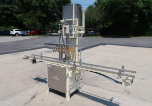 Used Mrm 6 Spout Semi-Automatic Pressure Gravity Filler, With Motorized Conveyor