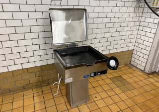Used Electrolux type 30128 frying table with manual tipping.
